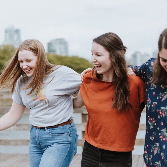 Three friends are laughing.